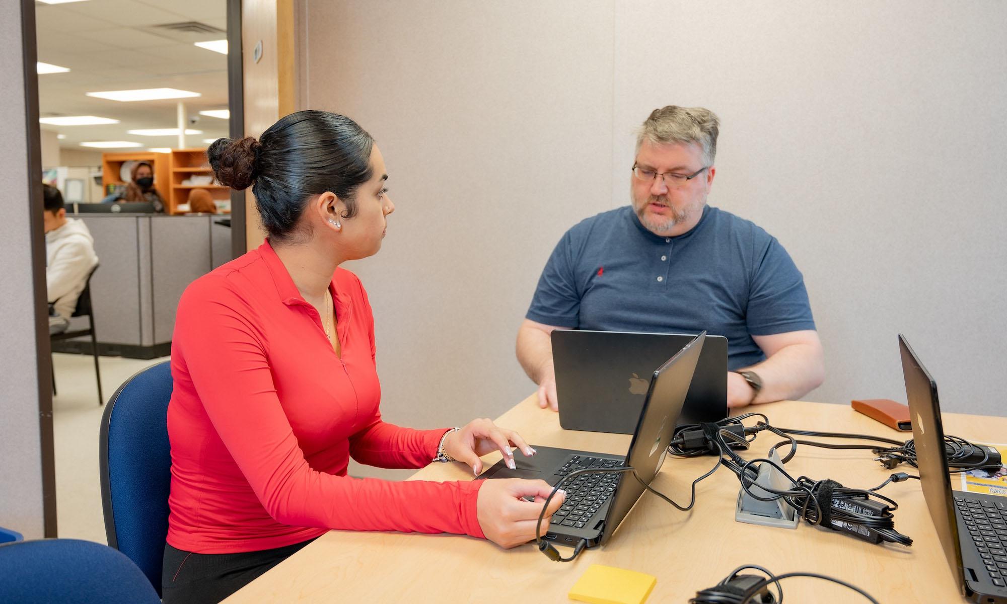 student meeting with an advisor at their office